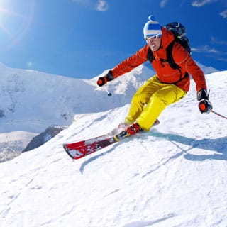 skier turming in deep snow and bright sunshine